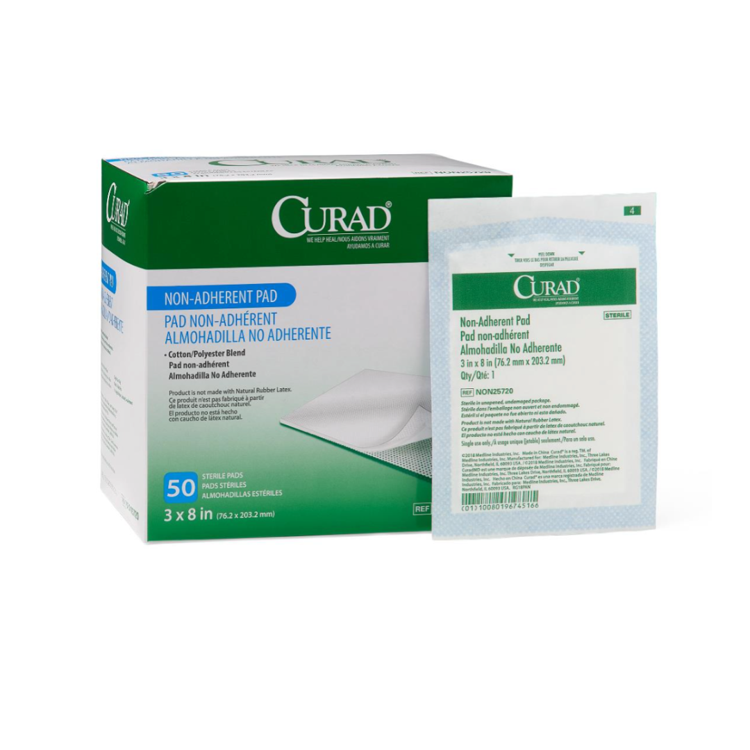 A green and white box of Medline CURAD Sterile Nonadherent Dressing Pads, 3x8 inches, contains 50 sterile pads. An individual nonadherent pad packet stands upright beside the box, displaying details in English and Spanish.